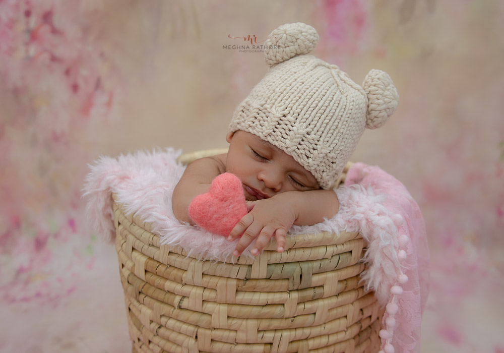 delhi gurgain baby photography baby sleeping in a basket with white cute cap meghna rathore photography