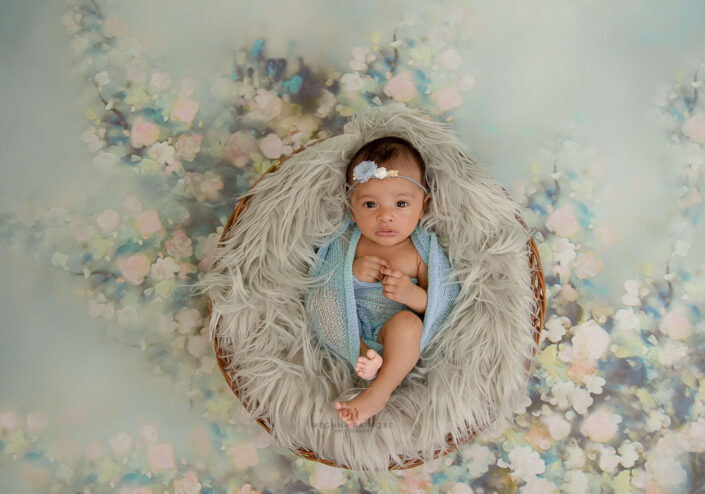delhi gurgaon best newborn photgrapher baby sitting in a basket on fur meghna rathore photography