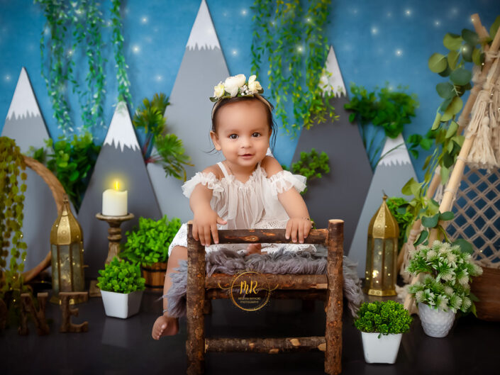 Kids Gallery – 1 Year Baby Girl Photoshoot With Blue Mountain, Pink Garden and Boho Theme.
