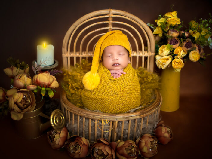Newborn Gallery - 18 days Baby Boy Newborn Photoshoot With Props Like Dream Catcher, Bed and Moon With Combination of Red, Green, Yellow and blue colors