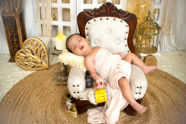 A baby peacefully sleeping on a chair with a bottle beside them captured by Delhi NCR's best maternal photographer Meghna Rathore.