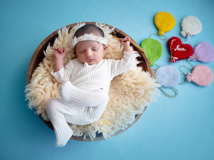 Newborn Gallery - 25 Days Baby Girl Photoshoot Using Swing, Shell, Moon, Bed with Red, Blue and Peachcolors