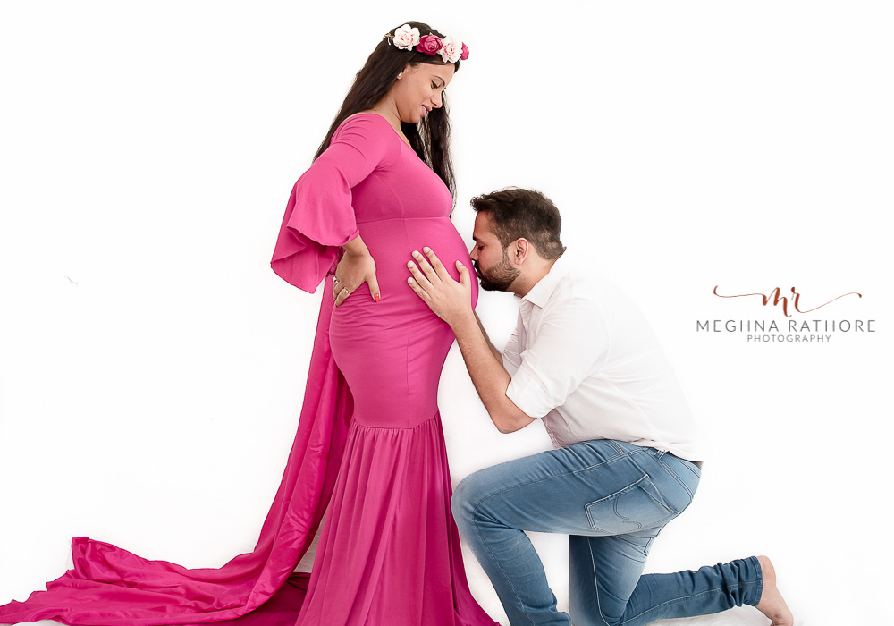 meghna rathore photography pregnancy photo session husband kissing expecting mother tummy