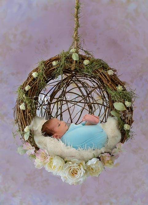 23 days old newborn baby boy posing with props and theme at meghna rathore photography in delhi