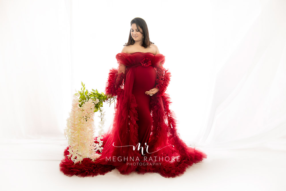 India Best Maternity Photographer in Faridabad, Pregnancy Photoshoot standing pose in wine maternity dress