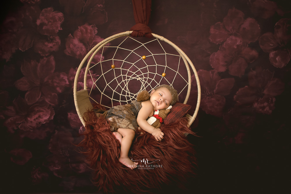 1 month old newborn baby girl photoshoot with flower setups, props by meghna rathore