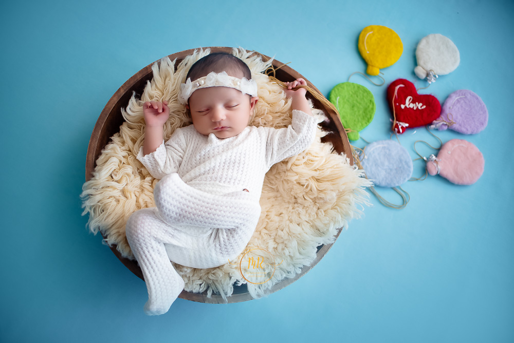 Newborn Gallery – 25 Days Baby Girl Photoshoot Using Swing, Shell, Moon, Bed with Red, Blue and Peachcolors