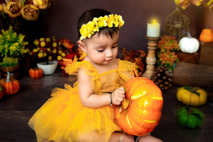The twining color of pumpkin and the little girls dress color wearing a tiara captured by Meghna Rathore Delhi NCR, Haryana best maternity and child photographer.