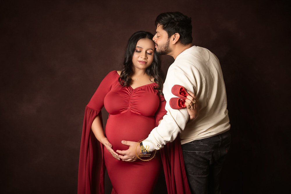 A couple feeling their upcoming happiness by experiencing their baby movement on mother's womb captured by Meghna Rathore, Delhi NCR's best maternity and child photographer.