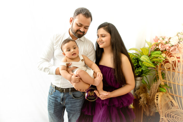 A young couple holding their six month baby boy during photoshoot captured by Meghna Rathore, Delhi NCR's best maternity and child photographer.
