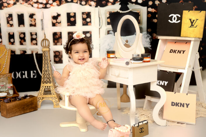 A baby in tutu posing like having her make-up in some French salon, captured by Meghna Rathore best maternal and child photographer in Delhi, NCR.