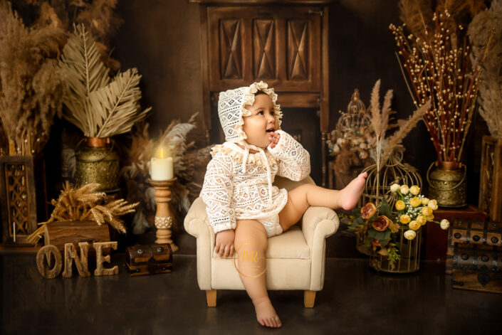Capturing the first birthday of the baby in an beautiful and esthetic view with flowers and candles captured by the best maternity and child photographer Meghna Rathore Delhi NCR, Haryana.