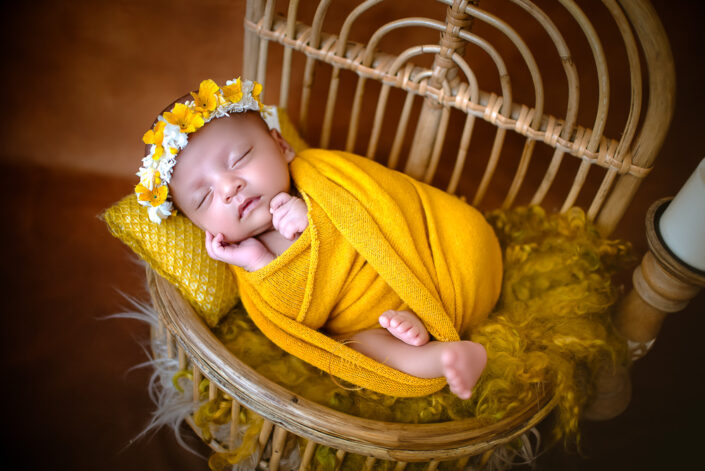 the charm of a baby’s one-month milestone with creative props and setting, evoking warmth and celebration by Meghna Rathore best maternity and child photographer.